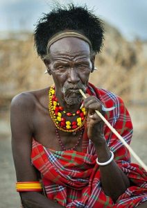 A man wearing an arash on his head, an ostrich-feather cap for male elders among the Turkana community of Kenya