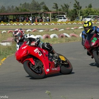 Dr. David Karuri, a respected surgeon and motorcycle enthusiast, leads the way into a corner at a biking event