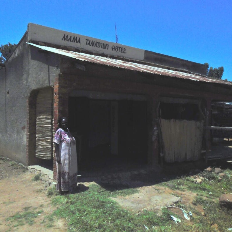 A lady standing outside a rural centre restaurant