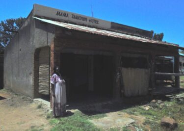 A lady standing outside a rural centre restaurant